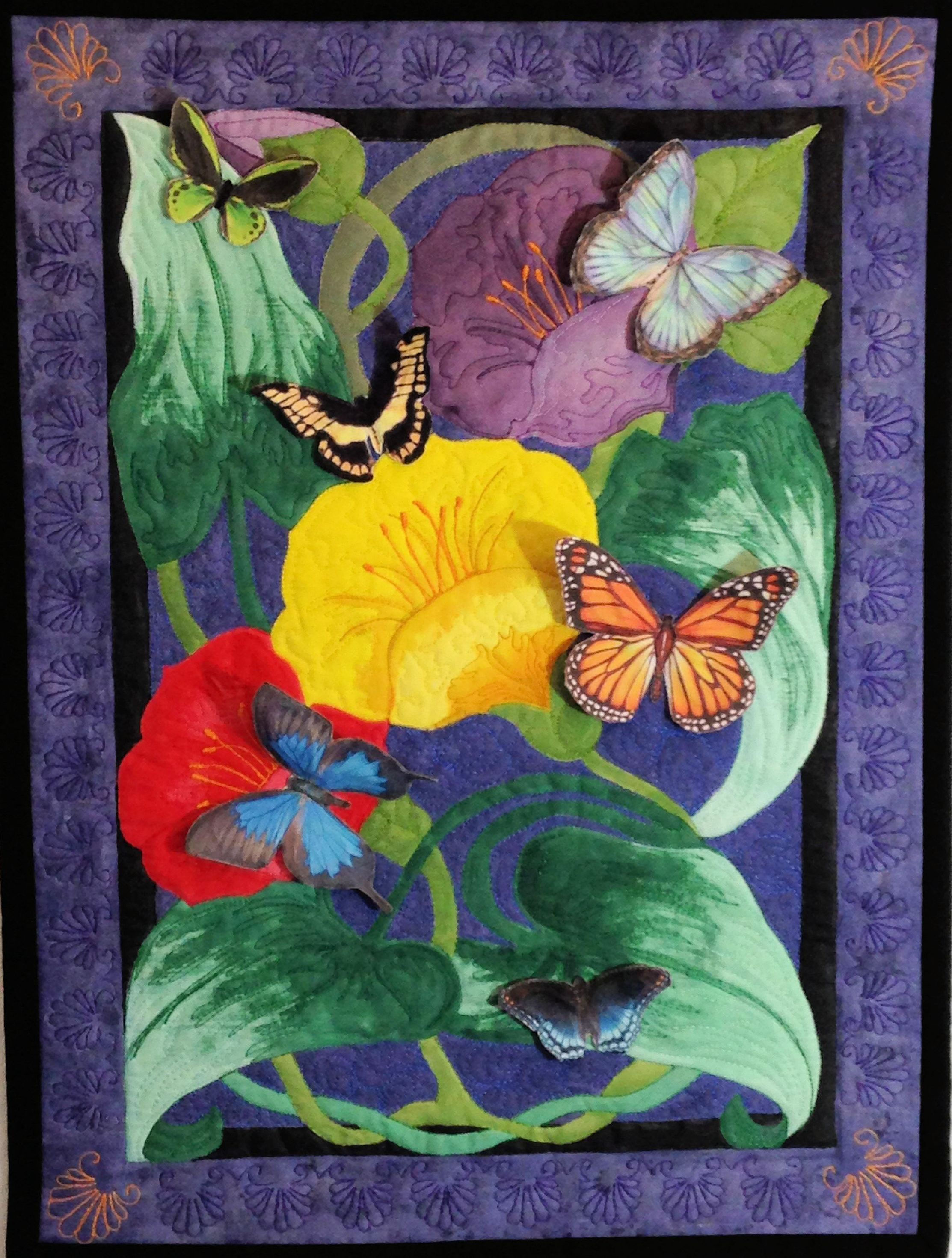 Butterfly Bait is a fiber art work in a art nouveau style with
colorful flowers surrounded by several three dimensional adjustable butterflies whose wings can be positioned in varying ways